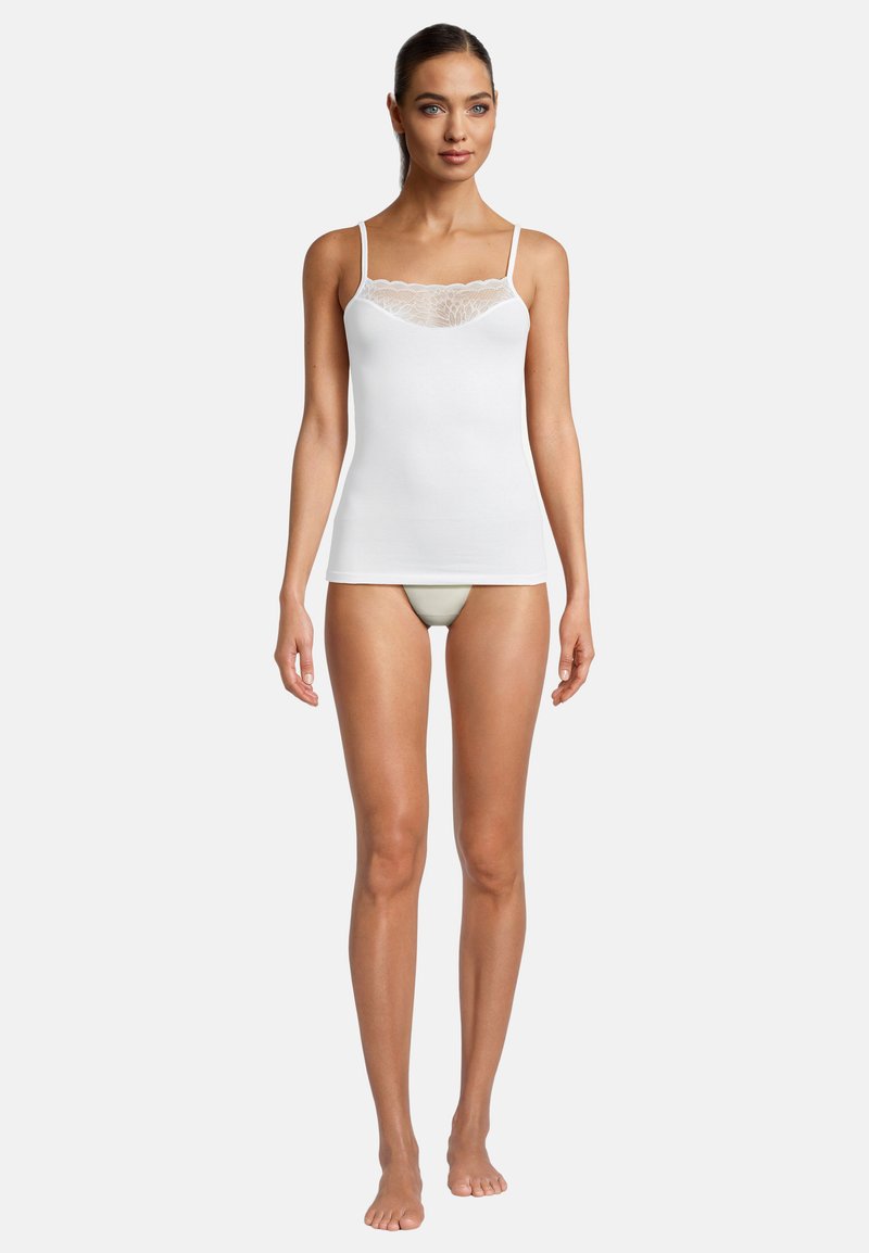 White tank top with thin straps, featuring a lace neckline detail. Smooth cotton fabric, fitted design, and hip-length cut.