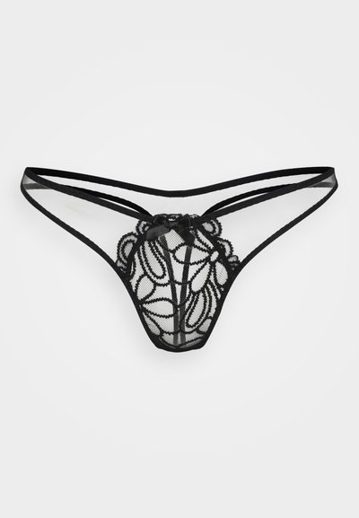 String en dentelle noire avec une broderie florale complexe, tissu transparent, et un petit nœud en satin à l'avant, doté de fines bretelles.