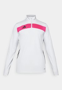 Vit långärmad atletisk tröja med en rosa panel och svarta detaljer, med en fjärdedels dragkedja och Adidas-logotypen på bröstet.