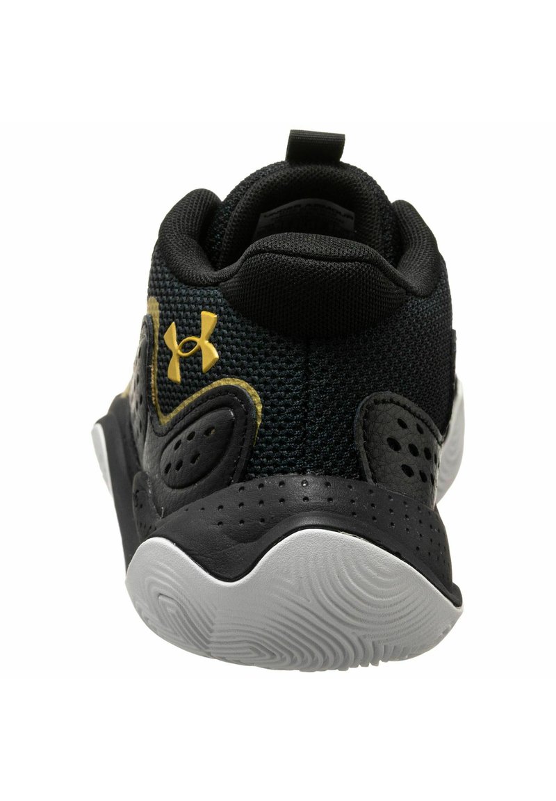 Baskets noires de sport avec une tige en mesh texturé, semelle en caoutchouc et logo doré. Présente un tirant à l'arrière et un support de talon moulé.