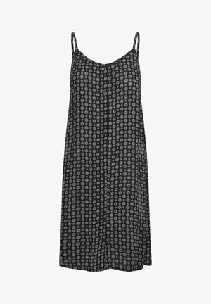 Robe noire sans manches avec fines bretelles et petit motif floral circulaire blanc sur toute la surface.
