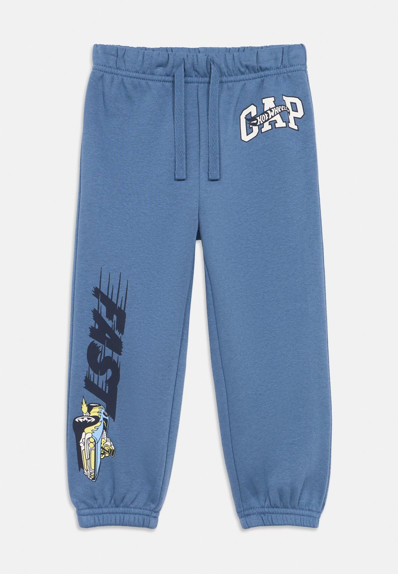 Blaue Jogginghose mit elastischem Bund, versehen mit dem "GAP"-Logo und einer Grafik mit dem Wort "FAST" in Schwarz am linken Bein.