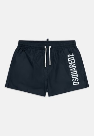 Mustad ujumispüksid elastse vööümbrisega, valgete nööridega ja valge "DSQUARED2" logoga paremal jalal.