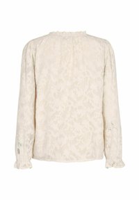 Blonde bluse i cremefarve med lange ærmer og flæsedetalje ved kraven; har et blomster mønster og samlede manchetter for tekstur og detalje.