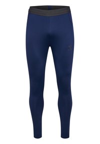 Leggings azul marino de tejido elástico, con una cinturilla elástica negra y un pequeño logo en el muslo izquierdo. Diseño ajustado sin bolsillos.