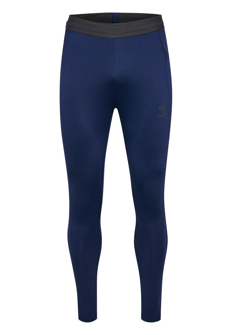 Leggings azul marino de tejido elástico, con una cinturilla elástica negra y un pequeño logo en el muslo izquierdo. Diseño ajustado sin bolsillos.