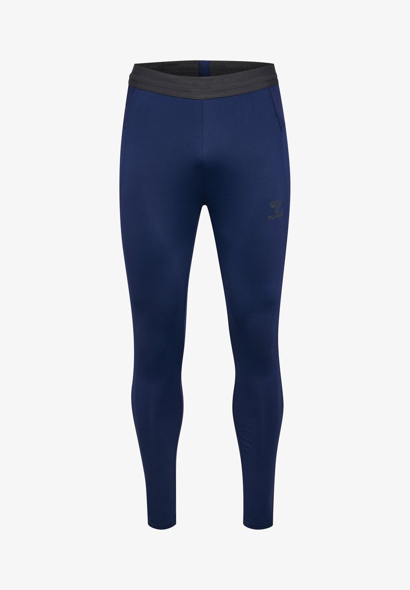 Marineblauwe leggings van rekbare stof, met een zwarte elastische tailleband en een klein logo op de linker dij. Slank model zonder zakken.