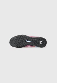 Sport shoe sole featuring a black rubber bottom with textured grip patterns, pink upper section with color accents in blue and orange.