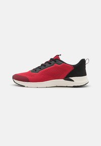 Red and black knitted athletic sneaker with black laces and white sole, shown in profile on white background.