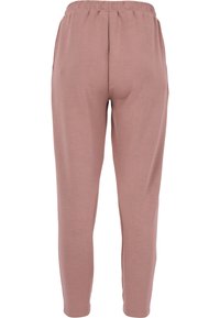 Ljusrosa loungebyxor med elastisk midja, smalnande ben och en mjuk, slät känsla. Inga synliga fickor eller hårdvarudetaljer.