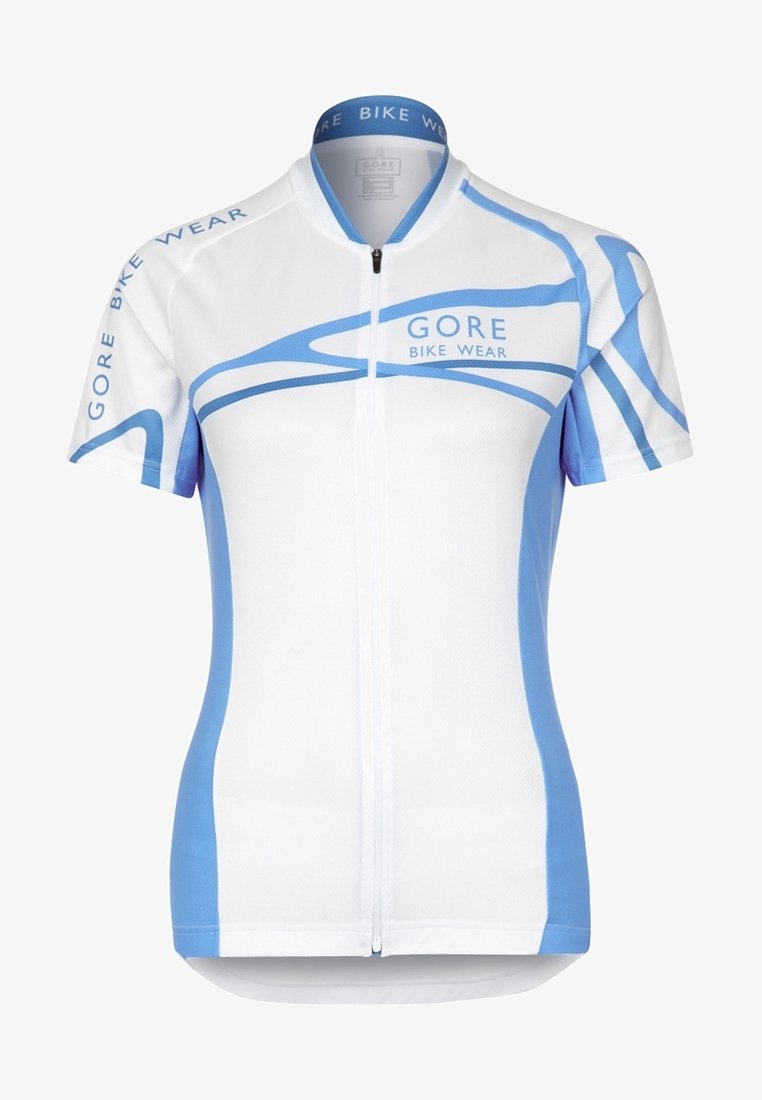 Kraťasy s krátkým rukávem na kolo v bílé barvě s modrými akcenty a vzory vln, vyrobené z prodyšné látky, vybavené celopropínacím zipem a stojáčkovým límcem.