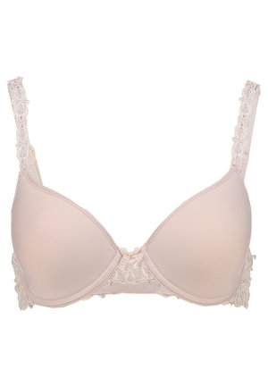Beige padded bra with lace detailing on the sides, adjustable straps, and a small bow at the center front. Smooth texture and contoured shape.