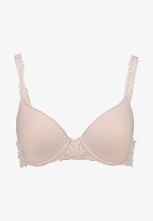 Beige padded bra with lace detailing on the sides, adjustable straps, and a small bow at the center front. Smooth texture and contoured shape.