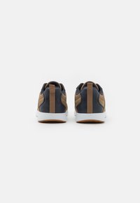 Navy and brown sneakers with suede and textile materials, featuring a white sole and back pull tab. Textured accents on side panels.
