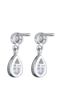 Silberne Tropfenohrringe in tropfenform, mit einem klaren Edelstein und geöffnetem dreieckigen Design, mit der Markierung "925" für Sterlingsilber.