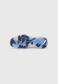 Puma athletic shoe outsole in translucent light blue with black abstract patterns, featuring textured treads and a white logo accent.