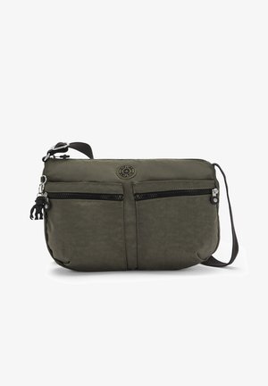 Olive green crossbody bag made of textured fabric, featuring two front zip pockets and a logo patch. Includes an adjustable strap and hardware.