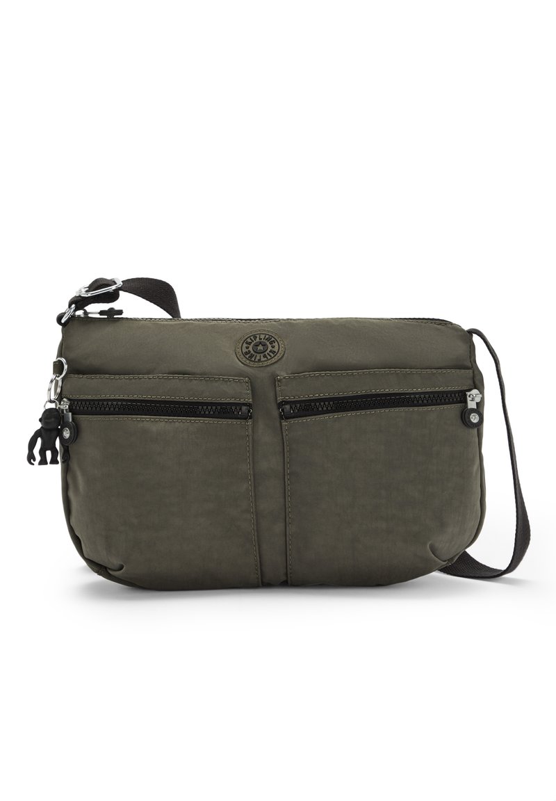 Olive green crossbody bag made of textured fabric, featuring two front zip pockets and a logo patch. Includes an adjustable strap and hardware.