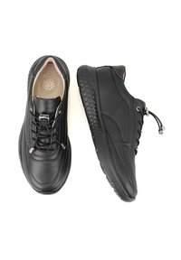 Schwarze Lederschuhe mit strukturierten Sohlen, runder Zehenpartie und Schnürdesign. Verfügen über ein dezentes Stichmuster und eine leichte Konstruktion.