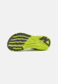 Shoe sole with a predominantly lime green color and black rubber sections. Features a textured pattern for traction and support.