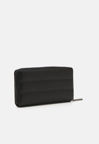 Calvin Klein LINE QUILT LARGE ZIP AROUND - Lompakko - black
