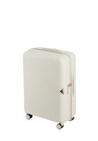 Hard-shell suitcase in off-white with diagonal ribbed texture, rose gold zipper, and four black wheels. Features a top handle and corner accents.