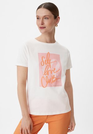 White cotton t-shirt featuring a peach and pink graphic print with the text "Self Love Club." Short sleeves and a classic crew neckline.
