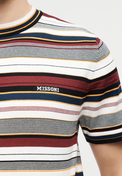 Close-up of a short-sleeve knit shirt with horizontal stripes in burgundy, navy, black, mustard, white, and gray, featuring "MISSONI" logo on chest.