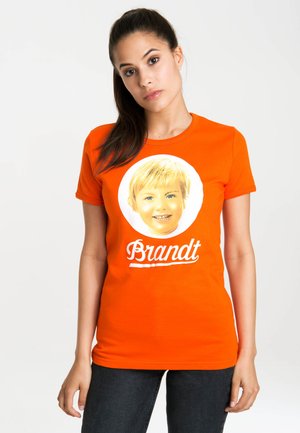 Orange cotton t-shirt featuring a round white graphic with a child's face and the name "Brandt" in a cursive font below.