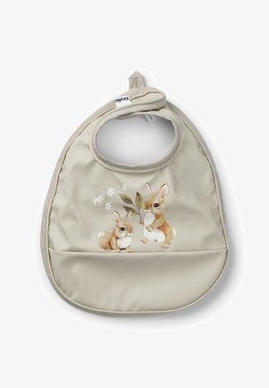 Vaahtokumista valmistettu beige essu, jossa on kaksi piirroshamsteria, jotka pitävät oksaa, ja alaosassa on tasku roiskeiden keräämistä varten.