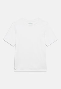 Λευκό βαμβακερό T-shirt με στρογγυλή λαιμόκοψη, κοντά μανίκια και μικρό πράσινο λογότυπο Lacoste κεντημένο στο κάτω αριστερό μέρος. Ομαλή υφή.