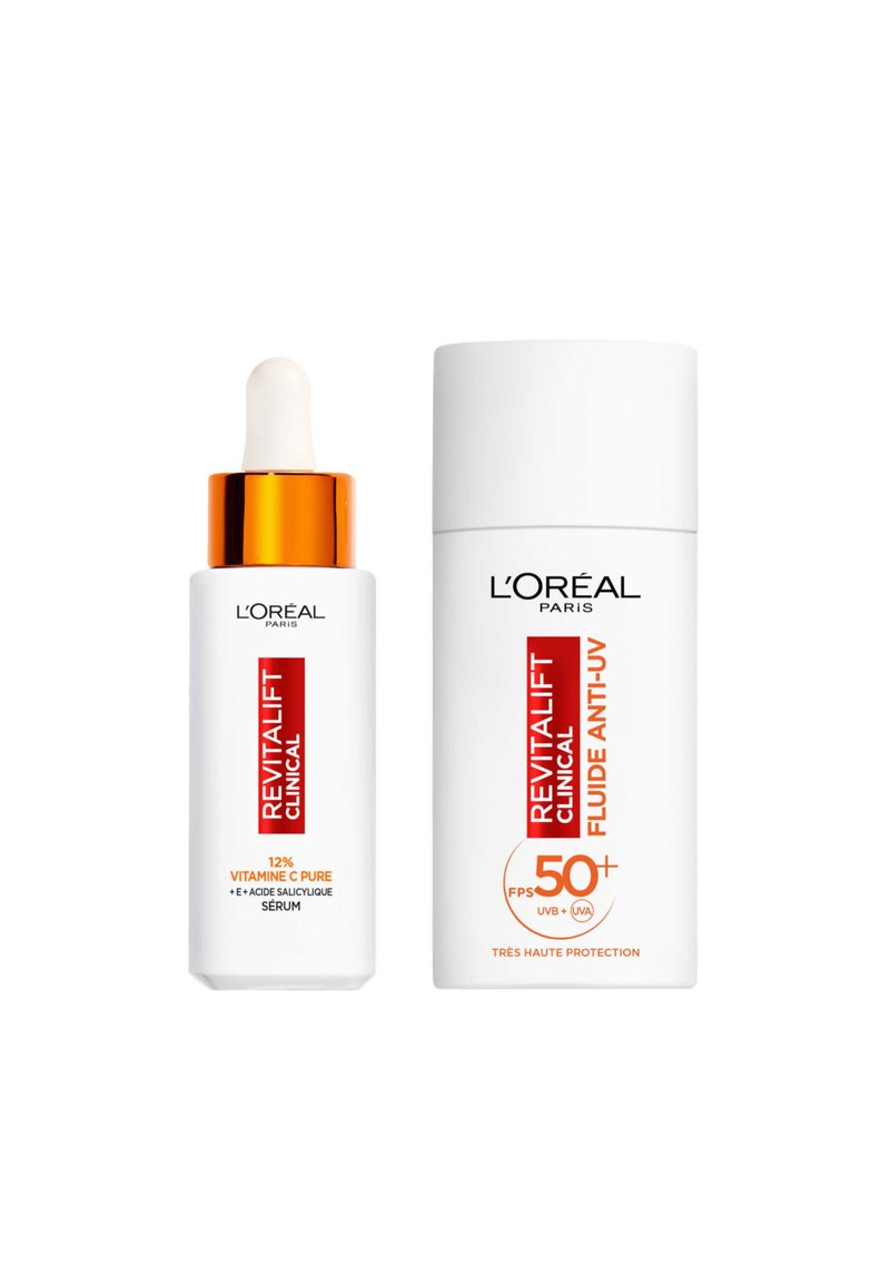 Sérum Revitalift Clinical avec un capuchon orange et pipette à côté du Fluide Anti-UV Revitalift Clinical. Les deux ont des contenants blancs avec du texte rouge.