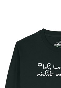 Zwarte sweatshirt gemaakt van biologisch katoen, met witte tekst die zegt "Ich habe nicht auf" in een casual handgeschreven lettertype.
