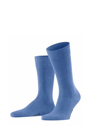 Chaussettes en coton bleu avec des ourlets côtelés, texture lisse, longueur cheville et bout renforcé. Logo noir sur la semelle.