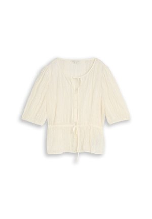 Blouse légère écrue avec manches trois-quarts, col rond, boutons sur le devant et taille ajustable avec cordon.