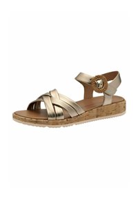 Guldmetallic sandal med ett vävt remdesign, justerbar vristrem, korkliknande sula och cirkulär dekorativ detalj.