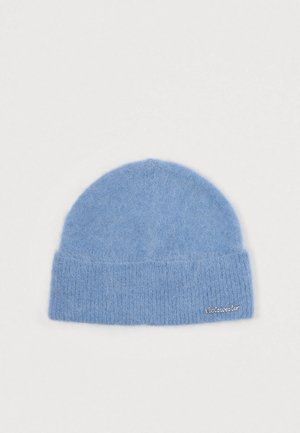 Gorro de malha azul claro, feito de material suave, com um punho canelado e um pequeno logótipo bordado de lado. Textura suave e felpuda.