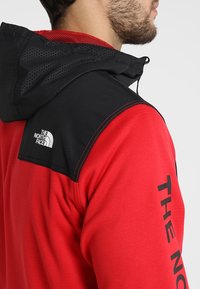 The North Face Fleecová bunda - red