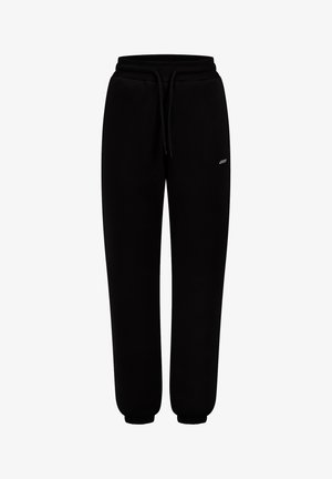 Schwarze Sweatpants aus weichem Material, ausgestattet mit einem elastischen Bund mit Kordelzug, seitlichen Taschen und gerippten Bündchen an den Knöcheln.