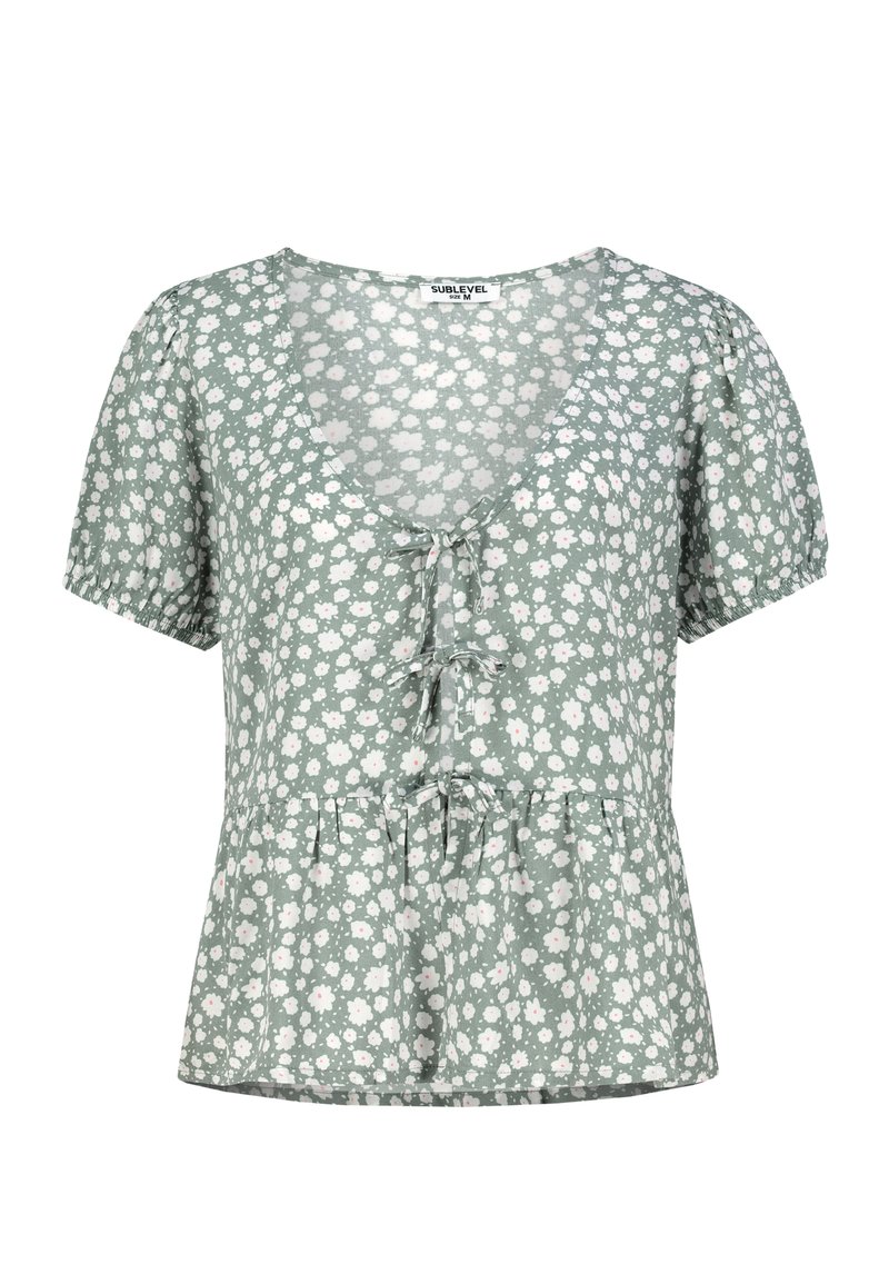 Blumenbluse in Hellgrün mit V-Ausschnitt, kurzen Puffärmeln und einem Peplum-Saum, verziert mit weißen und rosa Blumenmustern.