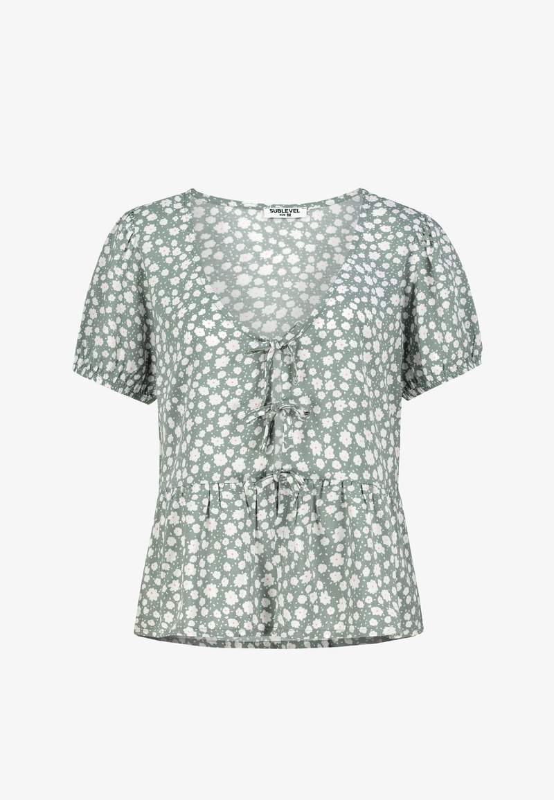 Blumenbluse in Hellgrün mit V-Ausschnitt, kurzen Puffärmeln und einem Peplum-Saum, verziert mit weißen und rosa Blumenmustern.