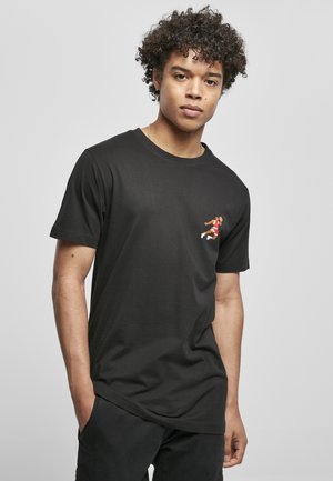 Black cotton t-shirt with short sleeves, crew neck, and a small colorful graphic of a figure on the left chest. Casual fit and smooth texture.