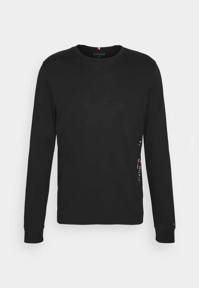 Black long-sleeve t-shirt made from cotton. Features a crew neck and a logo print along the left side. Smooth texture and regular fit.
