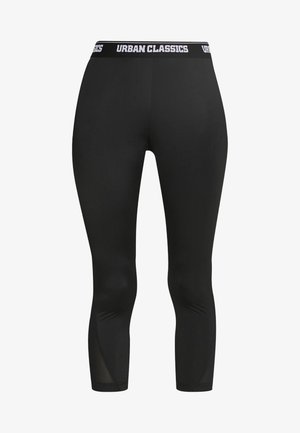 Mustad retuusid väljapeetud disainiga, valmistatud venivast materjalist. Omavad musta ja valge kaubamärgi trükiga vööd, lühendatud pikkust ja sujuvat tekstuuri.