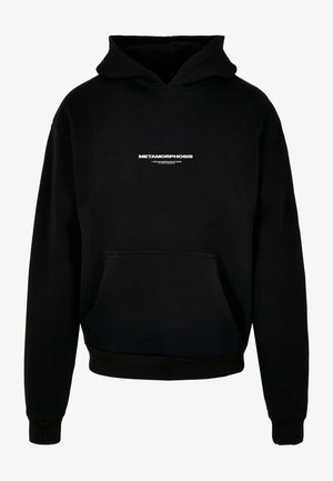 Mustapaita, joka on valmistettu puuvillasta, edessä tasku, ribattu hihansuu ja rinnassa valkoinen "METAMORPHOSIS" -logo.