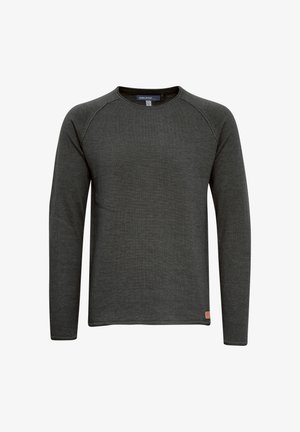 T-shirt à manches longues gris foncé en texture côtelée, avec un col rond et des manches raglan. Petite étiquette de marque en bas à gauche.