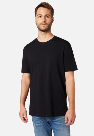 Black cotton short-sleeve T-shirt with a classic crew neckline, paired with distressed light blue jeans. Simple, solid color design.