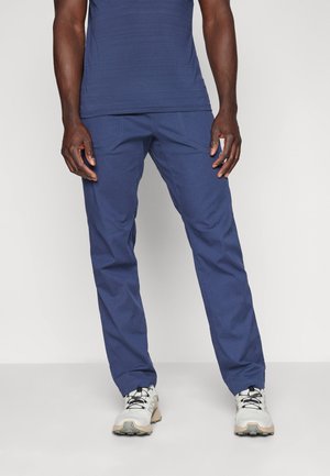 Navy blue trousers in a straight-leg fit, made of lightweight fabric with subtle texture, paired with gray athletic shoes.