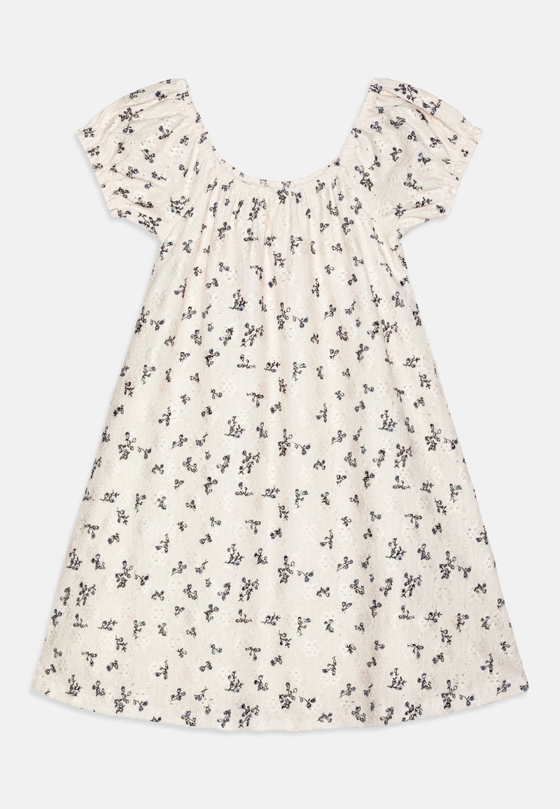 Robe en coton à coupe décontractée, avec des manches courtes bouffantes et un col rond. Elle présente un tissu beige clair imprimé de petits motifs floraux noirs.