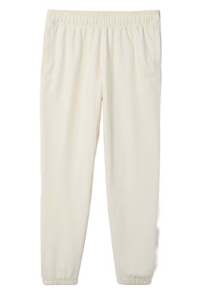 Cremfarbene Sweatpants mit elastischem Bund, seitlichen Taschen und schmal zulaufenden Bündchen. Hergestellt aus weichem, strukturiertem Stoff mit minimalistischem Design.